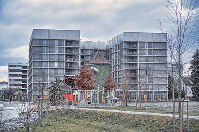 Exterior of building by field against sky