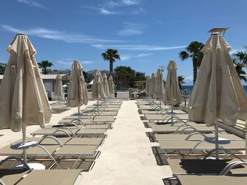 Chairs and tables on table against sky