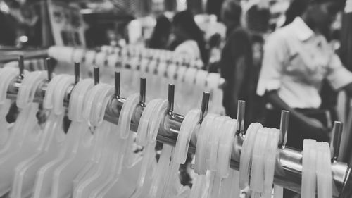 Close-up of coathangers hanging on rack in shop