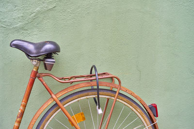 Close-up of bicycle against wall