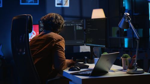 Midsection of woman using laptop at office