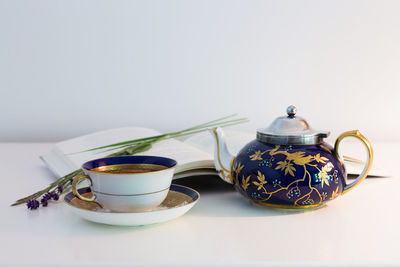 Coffee cup on table against white background