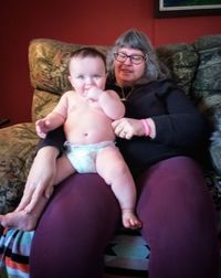 Happy friends sitting on sofa