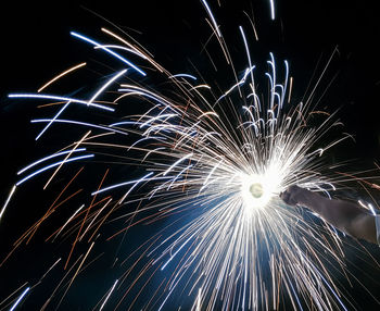 Low angle view of firework display at night