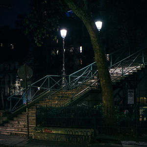 Low angle view of illuminated bridge against sky at night