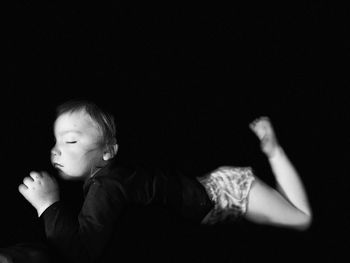 High angle view of young woman against black background