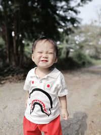 Portrait of cute boy standing outdoors