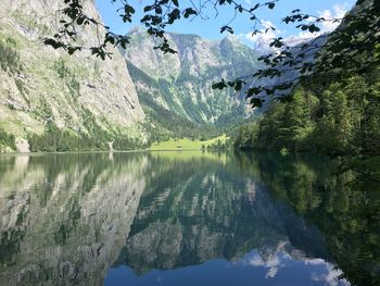 Scenic view of lake by trees against sky