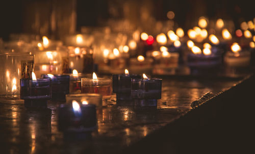 Close-up of illuminated candles on table