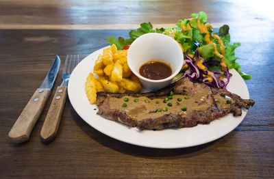 Meat and curry with french fries on plate