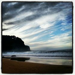 Scenic view of sea against cloudy sky