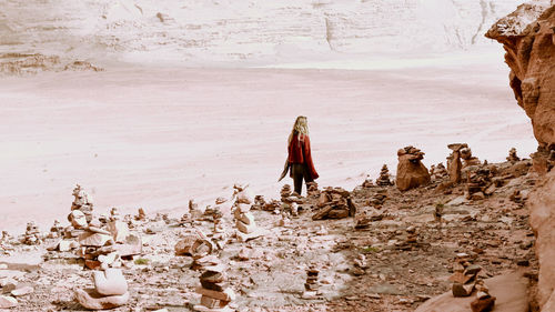 Rear view of woman walking on shore