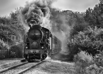 Train on railroad track against sky