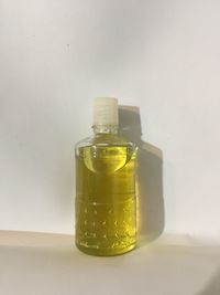 Close-up of glass of jar on table against white background