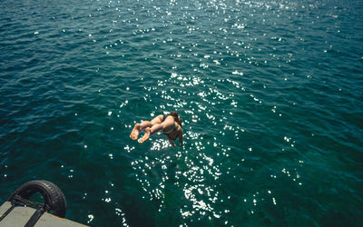 High angle view of woman diving into sea