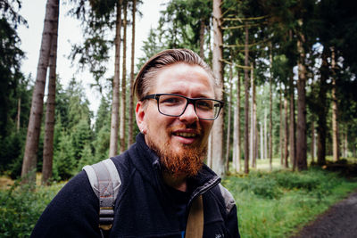 Portrait of man against trees in forest