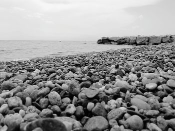 Rocks on beach against sky