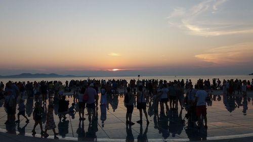 Group of people on promenade during sunset