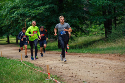 Full length of man running on green landscape