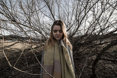 Portrait of a teenage girl with bare tree