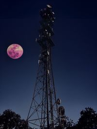 Low angle view of communications tower against sky