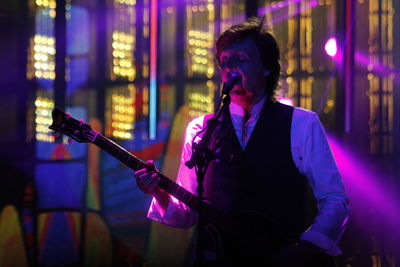 Man playing guitar at music concert