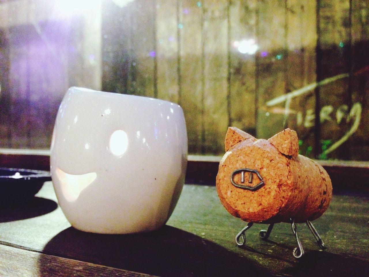 indoors, table, still life, close-up, focus on foreground, chair, no people, home interior, illuminated, food and drink, decoration, sweet food, absence, empty, candle, animal representation, restaurant, anthropomorphic face, celebration, wall - building feature