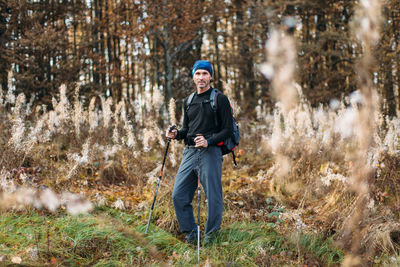 Portrait of mature man in camping equipment. autumn forest background