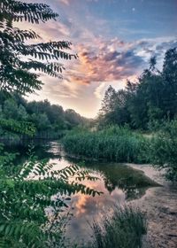 Scenic view of lake against cloudy sky