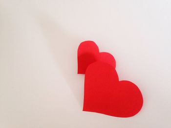 Close-up of red balloon over white background