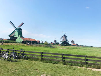 Traditional windmill on field against sky