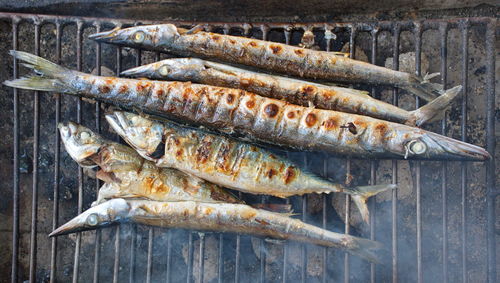 High angle view of fish on barbecue