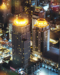 High angle view of illuminated buildings in city at night