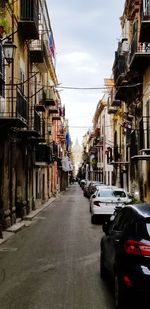 Cars on street amidst buildings in city