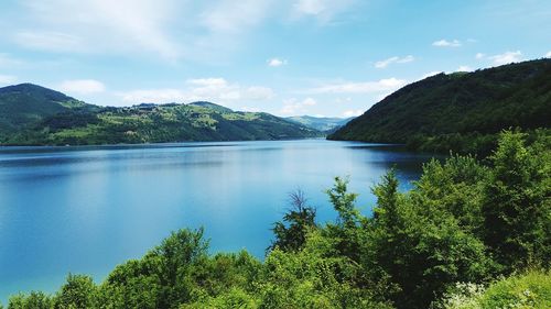 Scenic view of lake and mountains against sky