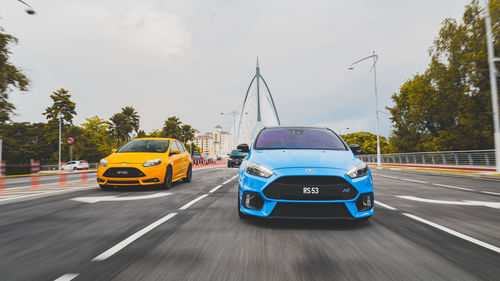 Cars on road against sky