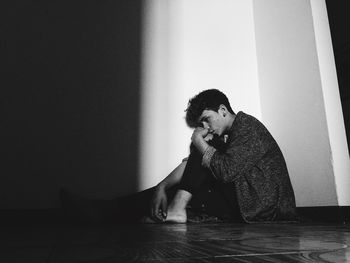 Young man sitting at home