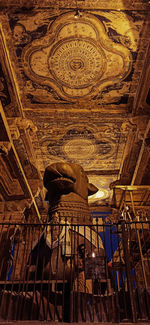 Low angle view of ornate ceiling in temple