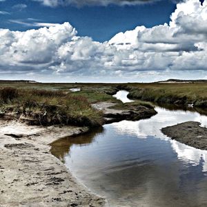 Scenic view of sea against cloudy sky