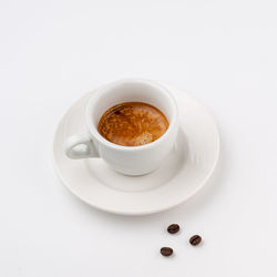 Close-up of coffee cup over white background