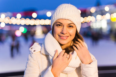 Portrait of smiling young woman in park during winter