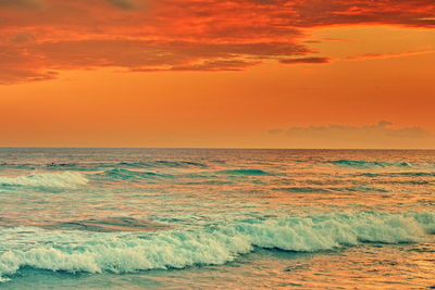 Scenic view of sea against orange sky