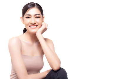 Portrait of a smiling young woman over white background