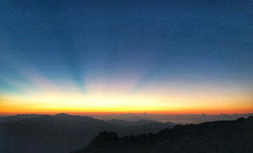 Scenic view of silhouette mountains against sky during sunset