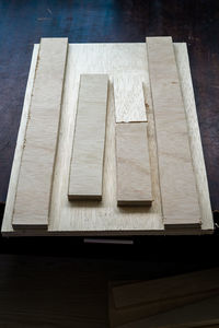 High angle view of wooden planks on table at workshop