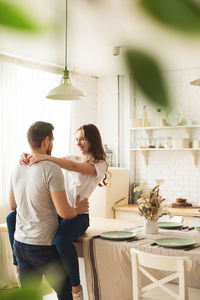 Young couple standing at home
