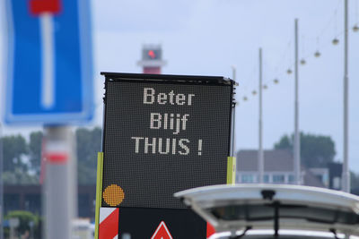 Close-up of road sign against blurred background