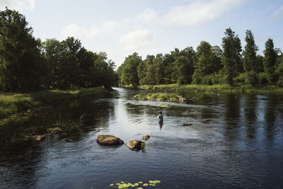 Person fishing in river