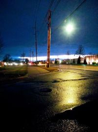 Cars on illuminated street at night