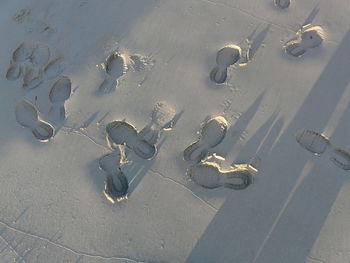 High angle view of footprints on sand